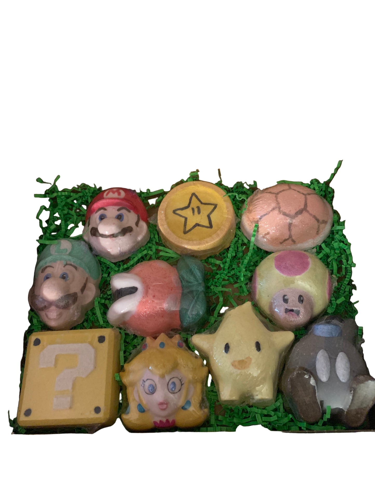 A variety of colorful bath bombs with Super Mario characters inside, arranged neatly in an open gift box.