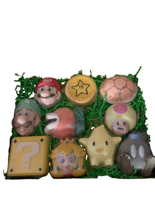 A variety of colorful bath bombs with Super Mario characters inside, arranged neatly in an open gift box.